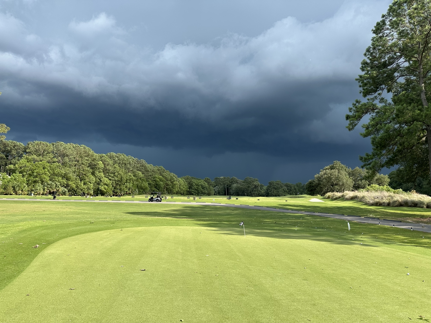 Driving range and thunder clouds